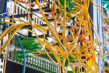 detail of server rack with fiber optic cables attached to front