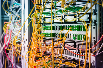 detail of server rack with fiber optic cables attached to front