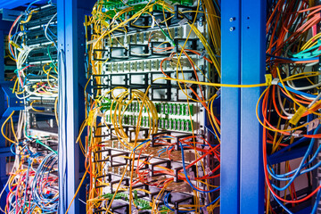 detail of server rack with fiber optic cables attached to front