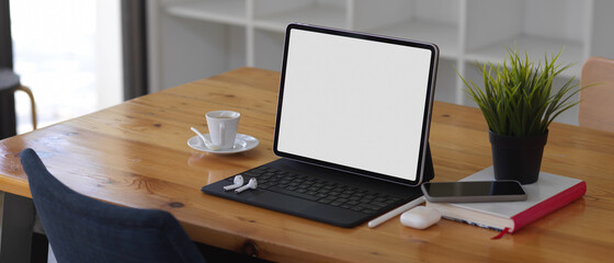 Wooden table with tablet, smartphone, accessories and book, include clipping path