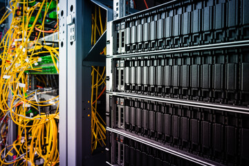 cluster of data storage SSD hard drives inside server rack