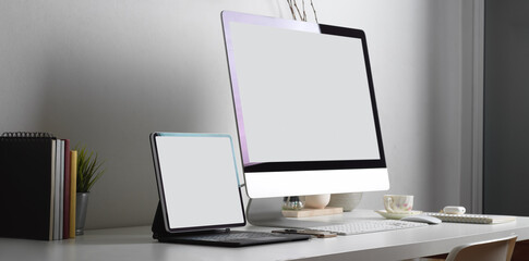 Worktable with tablet, computer and office supplies in office room, include clipping path