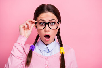 Close-up portrait of her she nice-looking attractive lovely pretty amazed brown-haired teen girl geek touching specs message information news reaction isolated over pink pastel color background