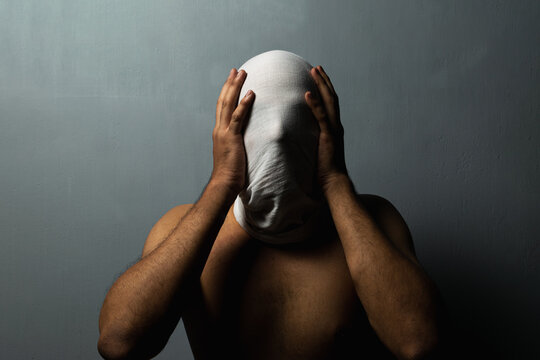 A sinister person's face covered in white cloth depicting ghost