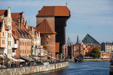 Fototapeta na wymiar The largest medieval port Crane in Europe and historic buildings on the Dlugie Pobrzeze over the Motlawa River in Gdansk, Poland.