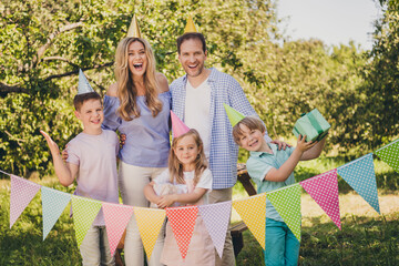 Portrait of nice attractive cheerful cheery gad full big family small little brother sister fatherhood motherhood friends friendship celebrating festal sunny day event occasion having fun © deagreez