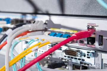 Fiber Optic cables connected to optic ports, network cables conn