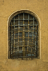 metal rusty window on a clay wall