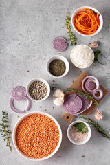dry red lentils in a white bowl with onions and spices