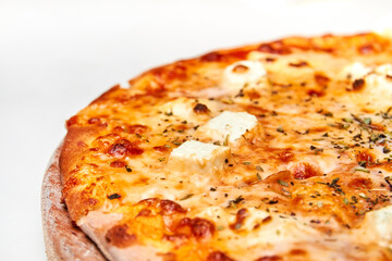 Pizza with cheese and herbs on a light background. Close-up, selective focus