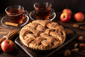 apple pie with cinnamon and hot black tea in glass cup