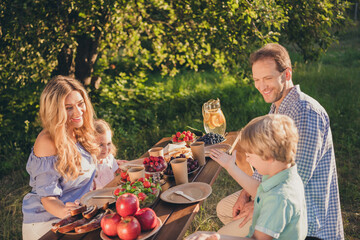 Photo of dream positive cheerful four people daddy mommy dad mom little kids sit table eat summer...