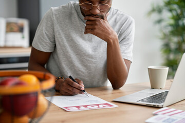 Front view of man fulfilling document of mail voting