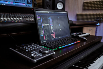 Close up of midi synthesizer with screen keyboard for creating music