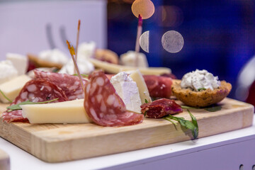 Italian salami, prosciutto, bacon ricotta and Cheese on wooden chopping board