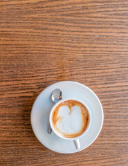 cappuccino coffee cup top vew closeup on wooden table, space for your text