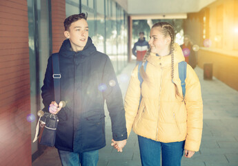 Young pretty couple of student boy and girl together outside happy smiling. Lifestyle people concept