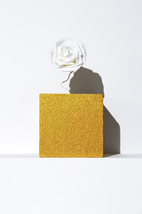Minimal golden cube and roses on white trendy shadows space. Fashion still life art. Geometric....