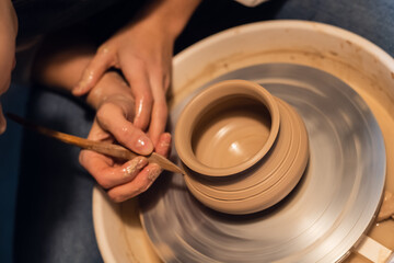Fototapeta na wymiar lesson in the school of pottery, sculpt a pot, close plan