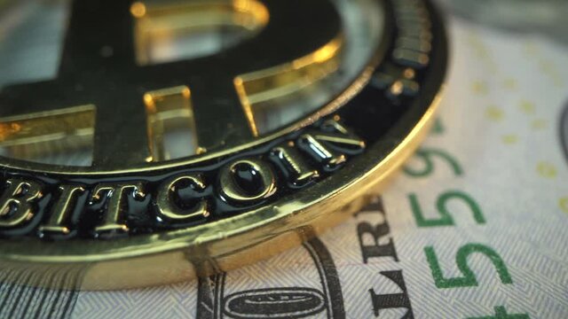American Dollars and cryptocurrency Bitcoin on the table. Macro sign ig Bit coin with panorama. Gold crypto coin against powerful US banknote. Blockchain technology. Money of the future. Digital