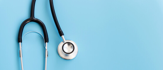 Stethoscope isolated on blue background, top view. Healthcare and medicine concept.