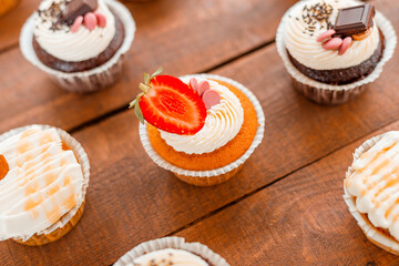 A nice picture of some delicious cupcakes on a wooden table