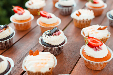 Some tasty cupcakes arranged on a wooden table