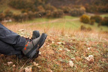 Photo of mans legs on a hill in autumn season