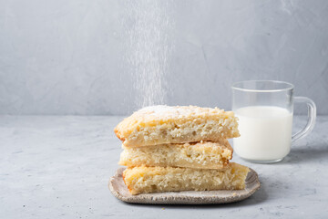 Homemade rustic pie with cottage cheese and milk   on a gray backgroun