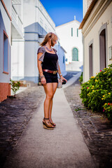 Woman enjoying the streets of an old village in the Algarve hills