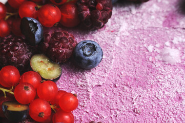 Festive cake, blueberry and blackberry sponge cake with cream cheese inside on a plate on a wooden table, horizontal view from above. 