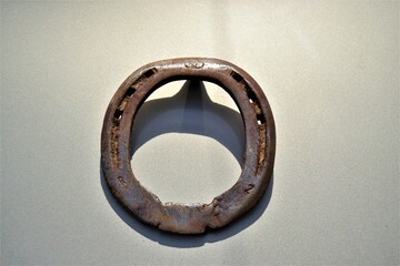Rusted, old and metal horseshoe. Hang a horseshoe on the door. Old and vintage lucky horseshoe.