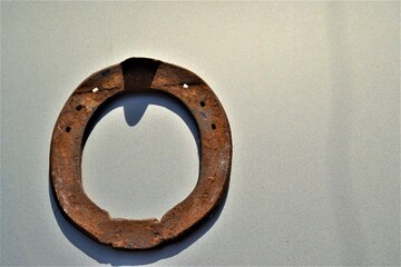 Rusted, old and metal horseshoe. Hang a horseshoe on the door. Old and vintage lucky horseshoe.