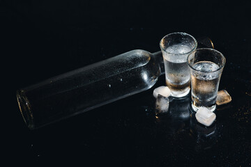 Vodka. Shots, glasses with vodka with ice .Dark background. Copy space .Selective focus