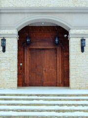 View of the massive wooden doors of the building on a snowy winter day