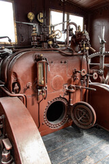 Old vintage steam locomotive cabin. Controls of a vintage steam locomotive, boiler and gauges.