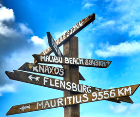Signpost indicating the distance to beautiful places with good beaches