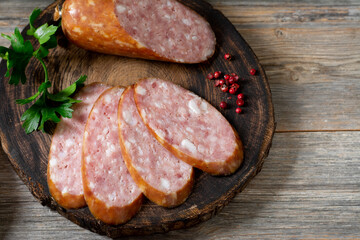 Sausage. Smoked sausage with spices on a wooden serving Board. Tasty meat sausages made from turkey...