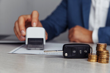 Rental agreement for a car with contract, stamp and key.