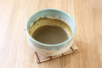 Matcha green tea in ceramic  cup on wooden plate, Japanese matcha tea is beverage of japanese
