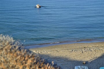 Horizon line: Marmara Sea and blue sky. Coast, blue sea, beach, rocky, raft in the same photo during sunny day of Mudanya, Bursa, Turkey.