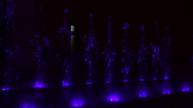 Beautiful musical fountain with colorful illumination in the evening in Kiev Ukraine 4k video