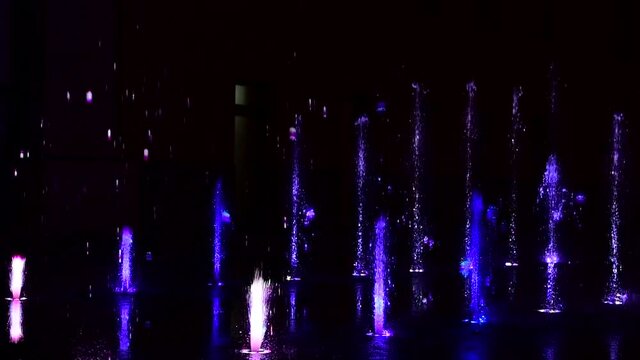 Beautiful musical fountain with colorful illumination in the evening in Kiev Ukraine 4k video