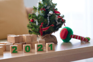 Small Christmas tree and numbered wooden blocks 2021, in living room