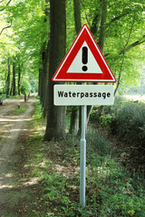 Warning sign for a ford in a rural forest road near Winterswijk, Netherlands