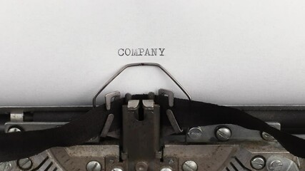 to type quote company on a vintage and old typewriter close-up
