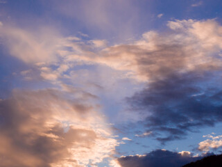 Naklejka na ściany i meble Dramatic sky with clouds at sunset. Skyscape with ray beams.