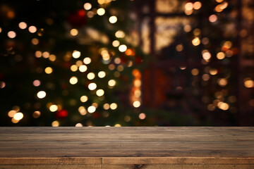 Empty table in front of christmas tree with decorations background. For product display montage