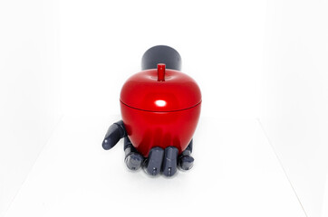 robotic hand with artificial apple
