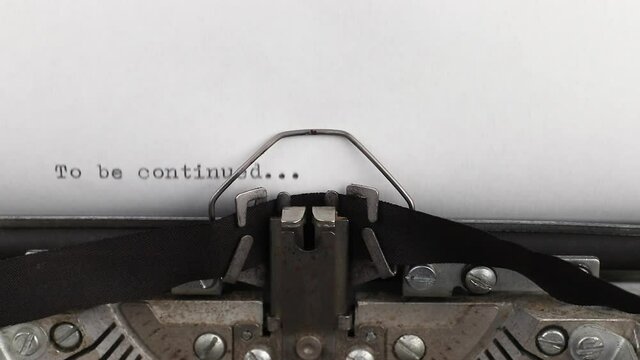 to type a quote to be continued on a vintage and old typewriter close-up
